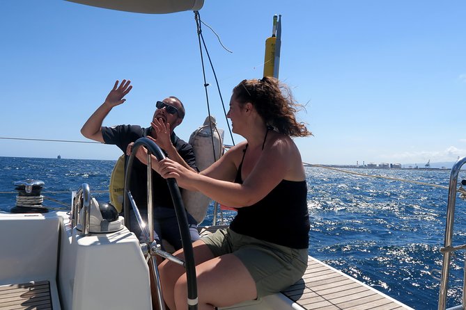 Amazing 2 hour Exclusive Sunset Cruise from Barcelona - Onboard comfort: drinks, steering the wheel, and crew energy