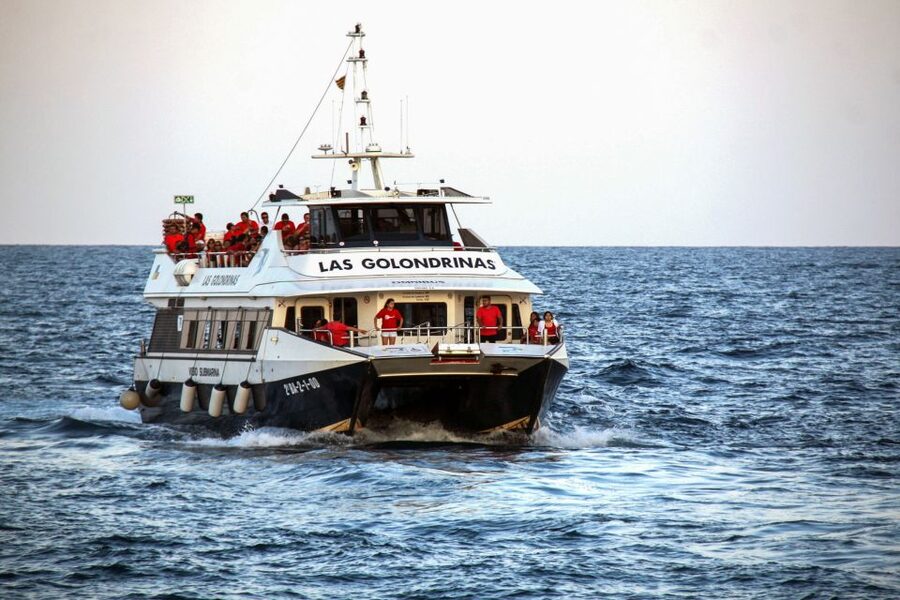 Barcelona: Boat Tour in Las Golondrinas - The onboard vibe: space, bar service, and photo touches