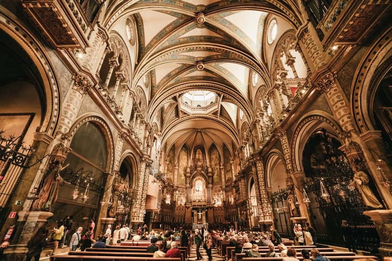Barcelona: Montserrat, Cogwheel, Black Madonna & Winery Tour - Entering Santa Maria de Montserrat Abbey: what the guided walk adds