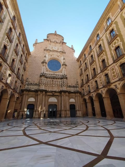 From Barcelona: Montserrat Monastery & Hike with Cable Car - Back at the monastery: farmers market tasting and a more local Montserrat